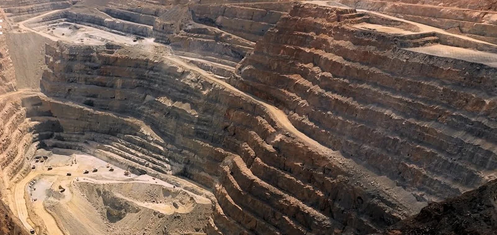 Wide aerial view of the KCGM Super Pit showing terraced mine levels, haul roads and active operational areas