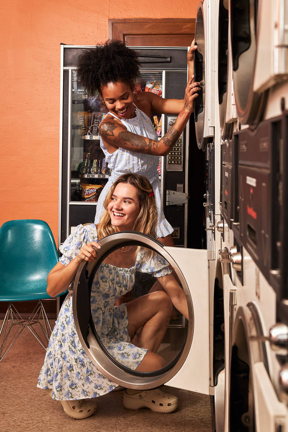 Trixxi Back to school embracing dorm life doing laundry hanging out in a blue floral printed romper and white with blue floral print tier dress.