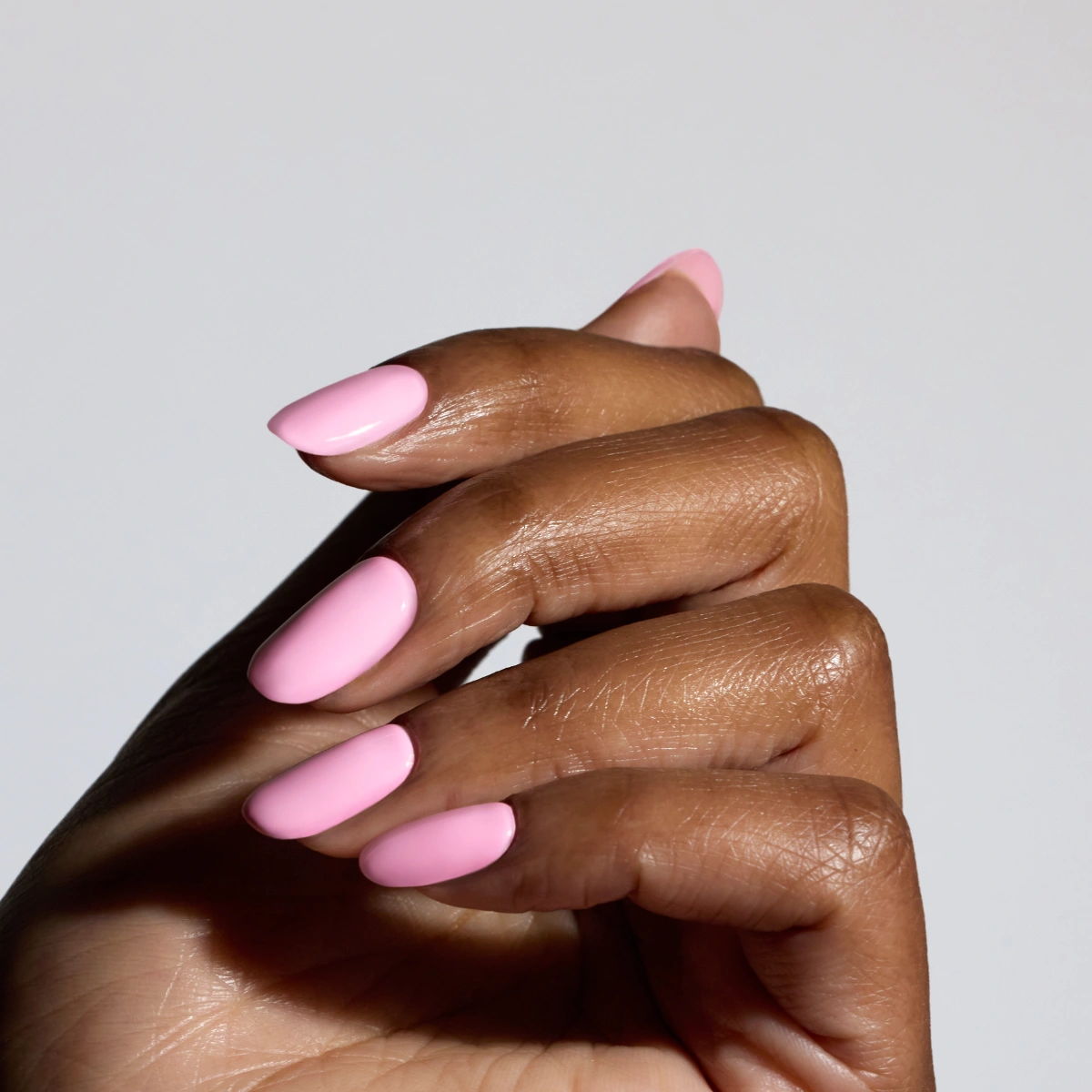 Shade Resort from Glossify's Endless Summer collection on a deep skin tone.