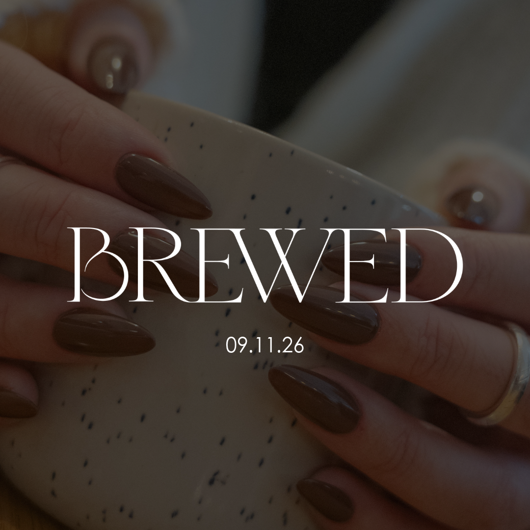 Hands holding a speckled bowl with the word 
