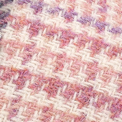 Pink, cream and white Harris Tweed fabric with soft woven herringbone texture.