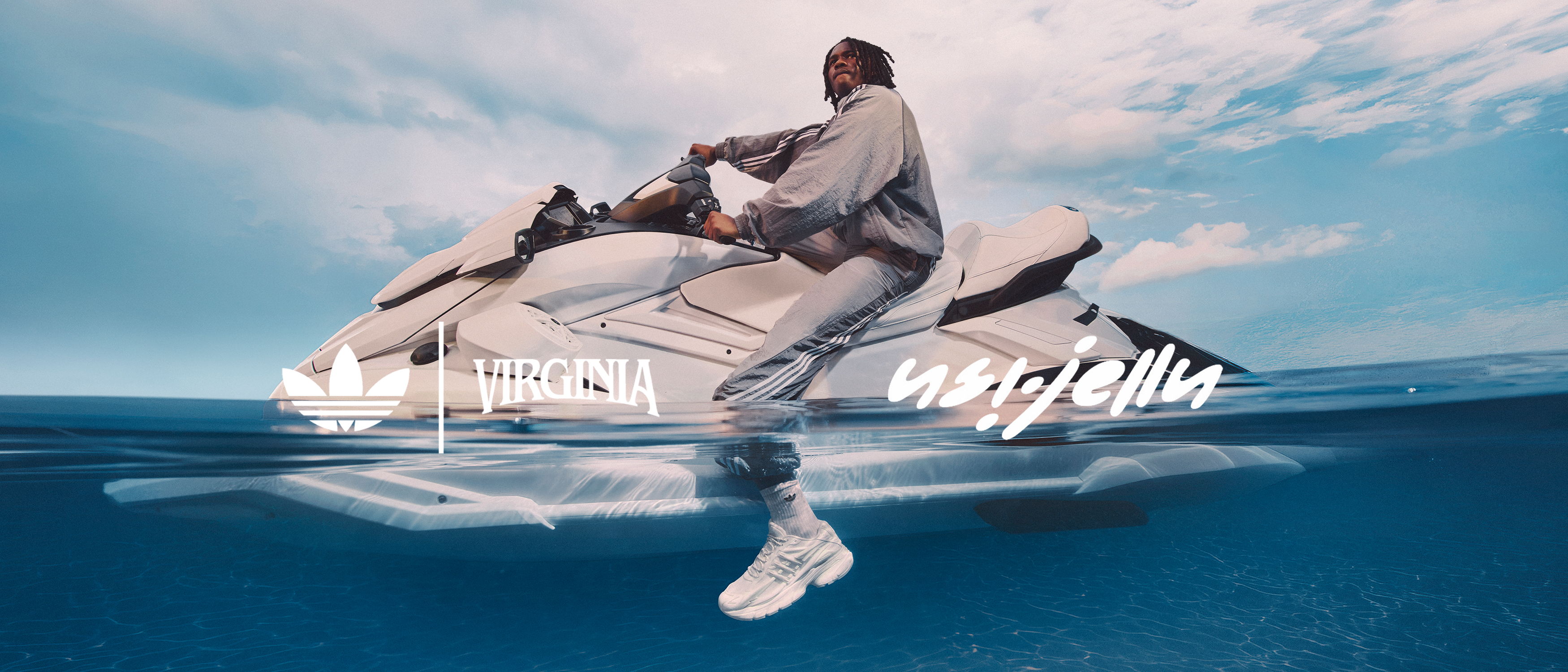 Person riding a jet ski on water with a blue sky background.