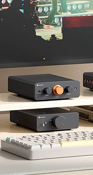 Two audio interface devices on a desk, with a keyboard nearby.