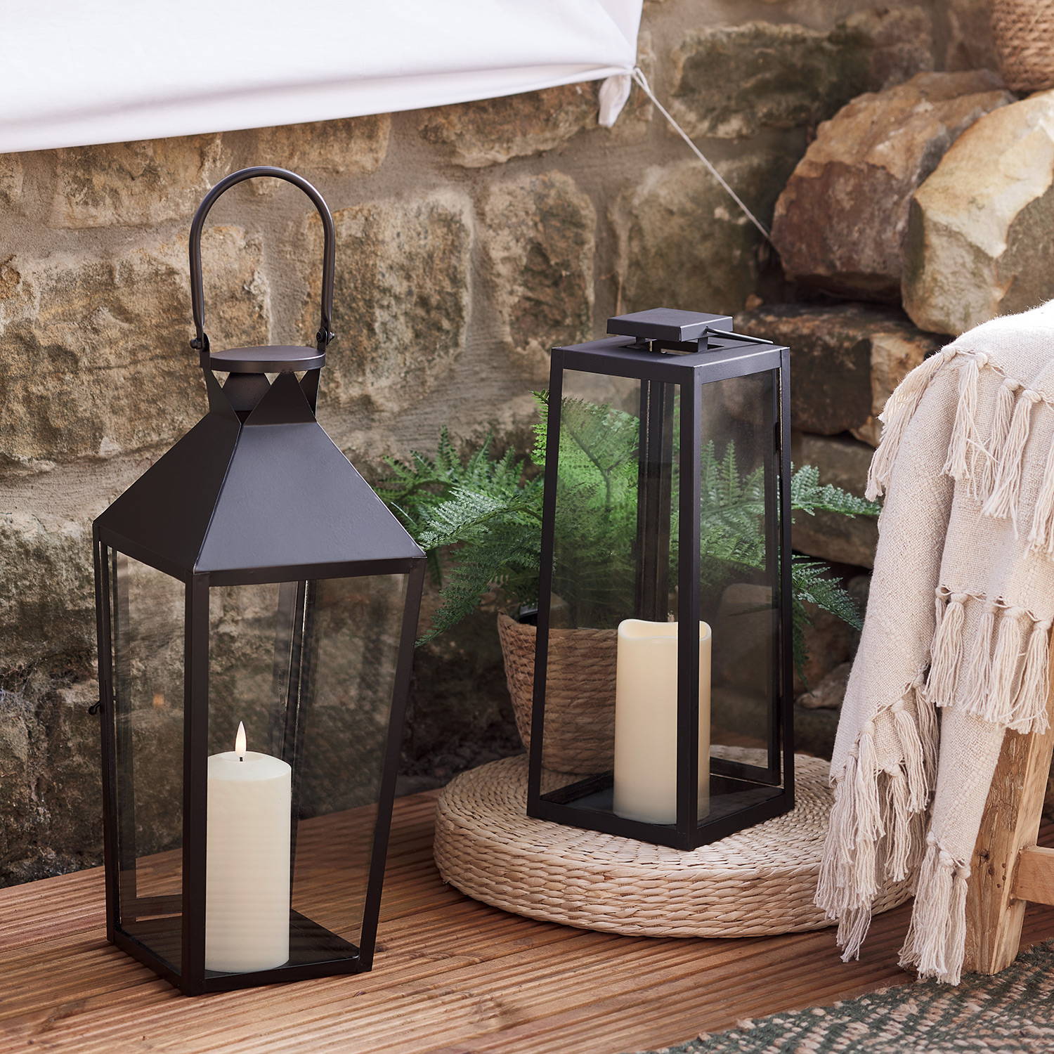 2 black outdoor lanterns as part of an outdoor movie night setting.
