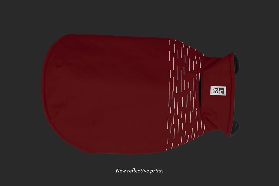 Red garment with a patterned design on the front against a dark background.