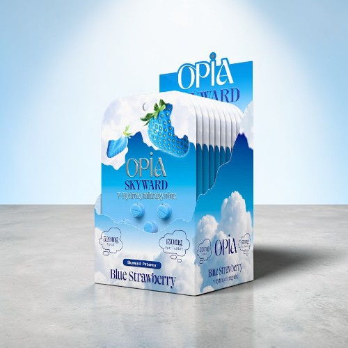 Box of Opia Skyward blue strawberry-flavored candy on a gray surface.