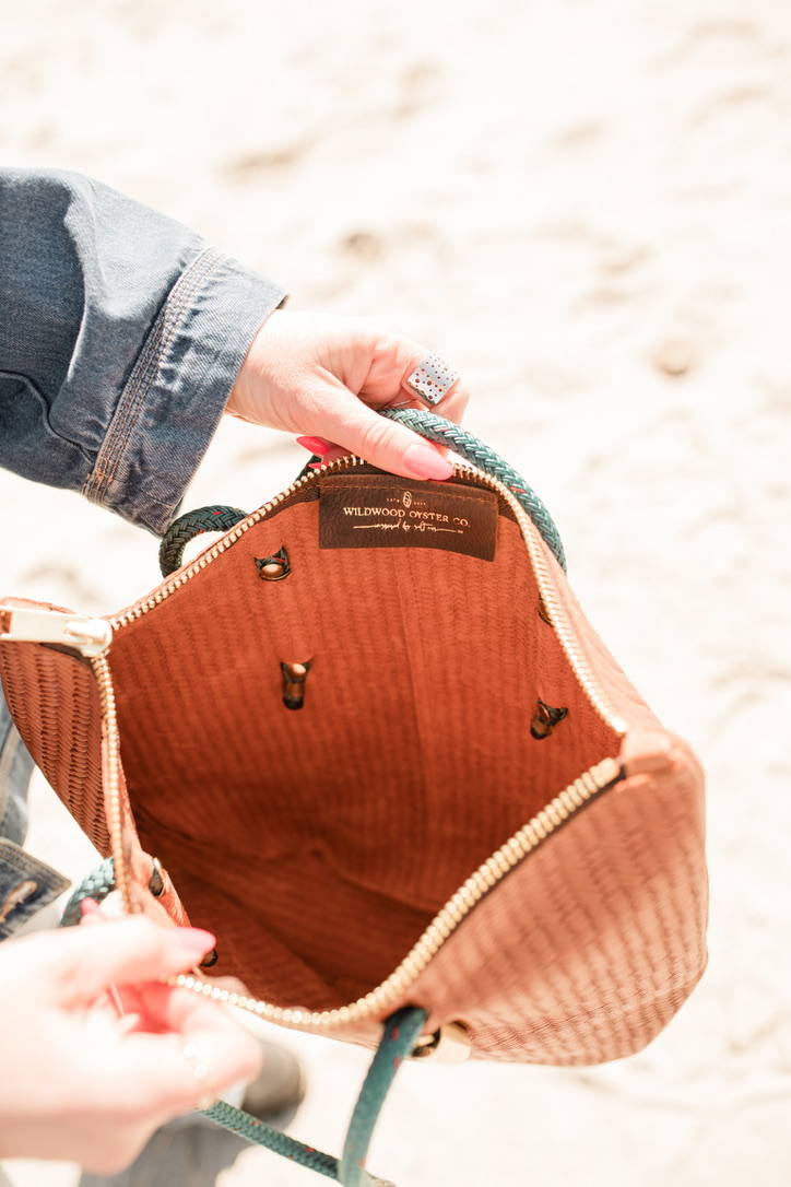 closeup of brown basketweave zip bag held open