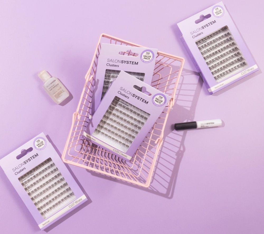 Beauty products in a pink basket on a purple background.