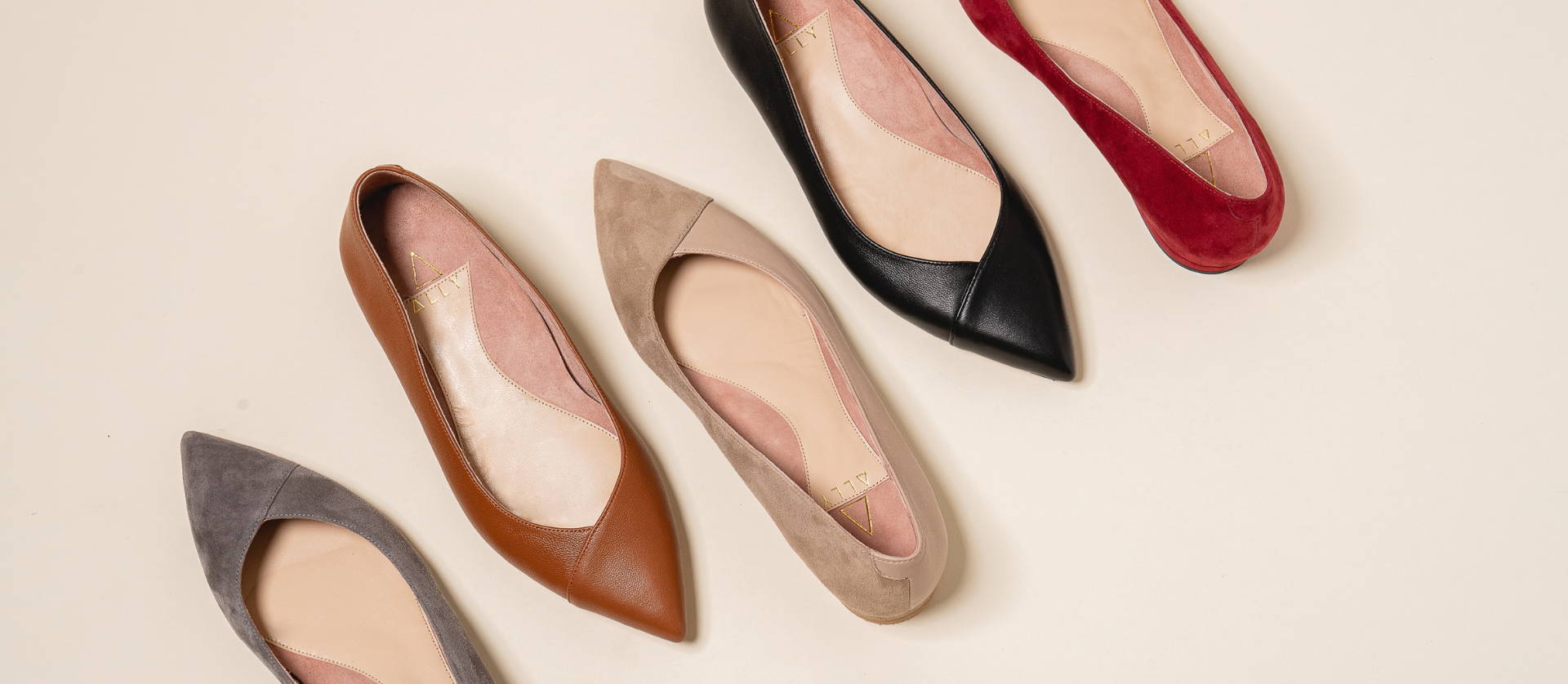 Five pairs of stylish women's pointed-toe flat shoes in various colors.
