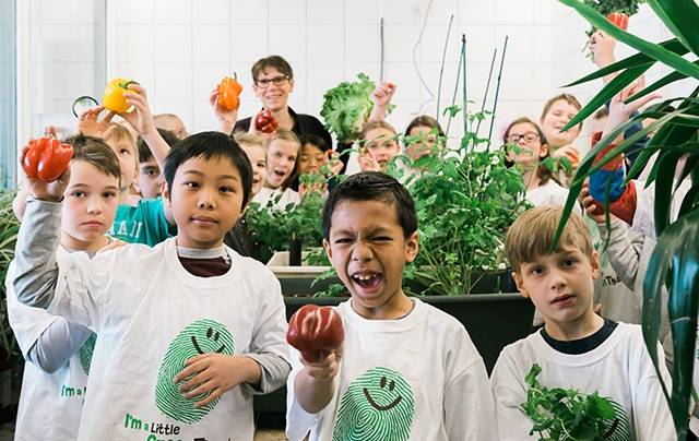 Students and teacher with their EarthBox harvest