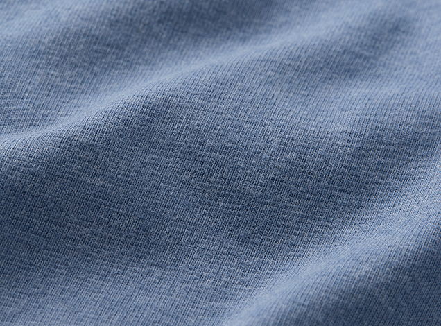 Close-up of textured blue fabric with subtle wrinkles.