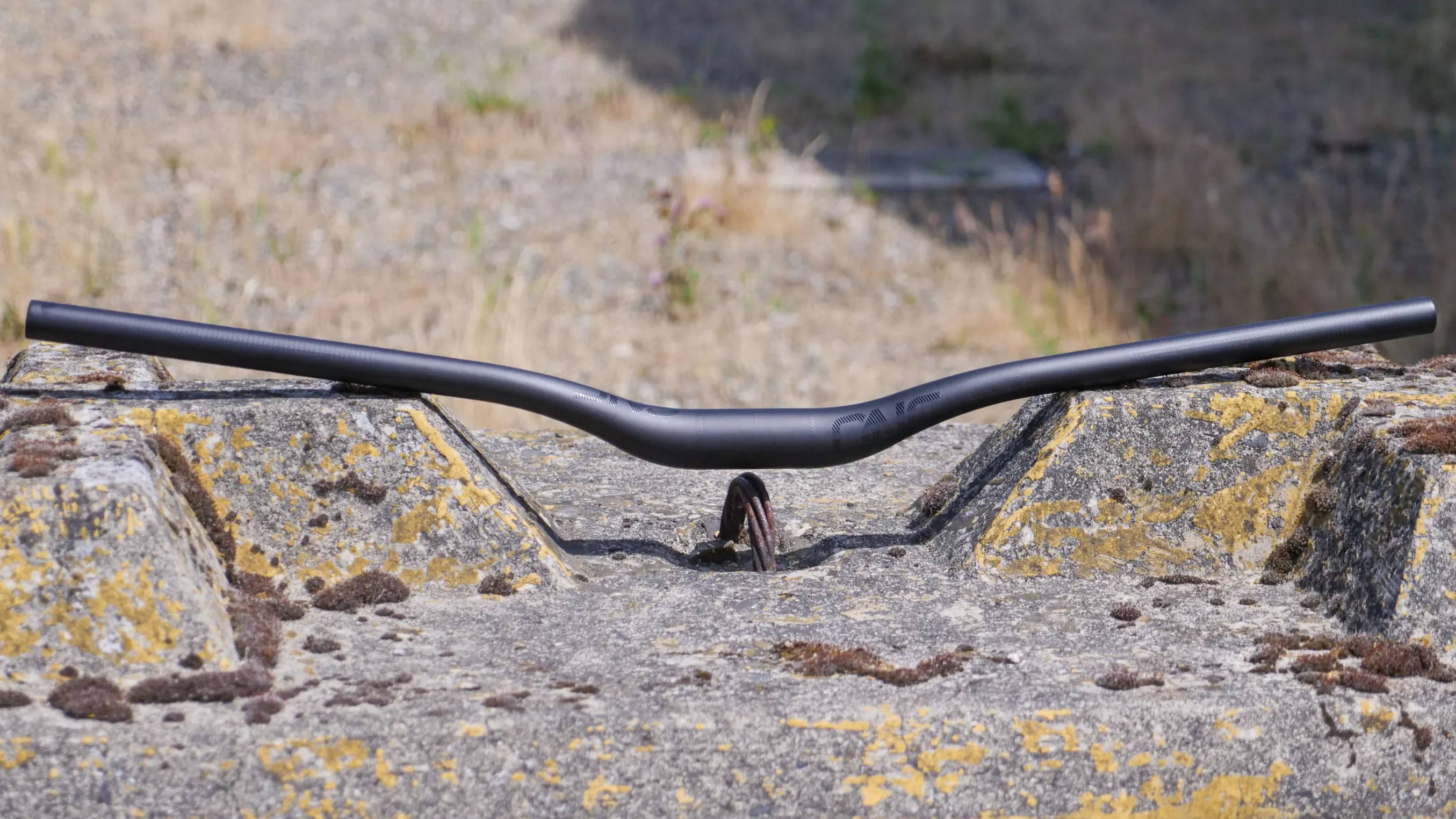 oneup components carbon handlebars with 35mm rise set on a jersey barrier
