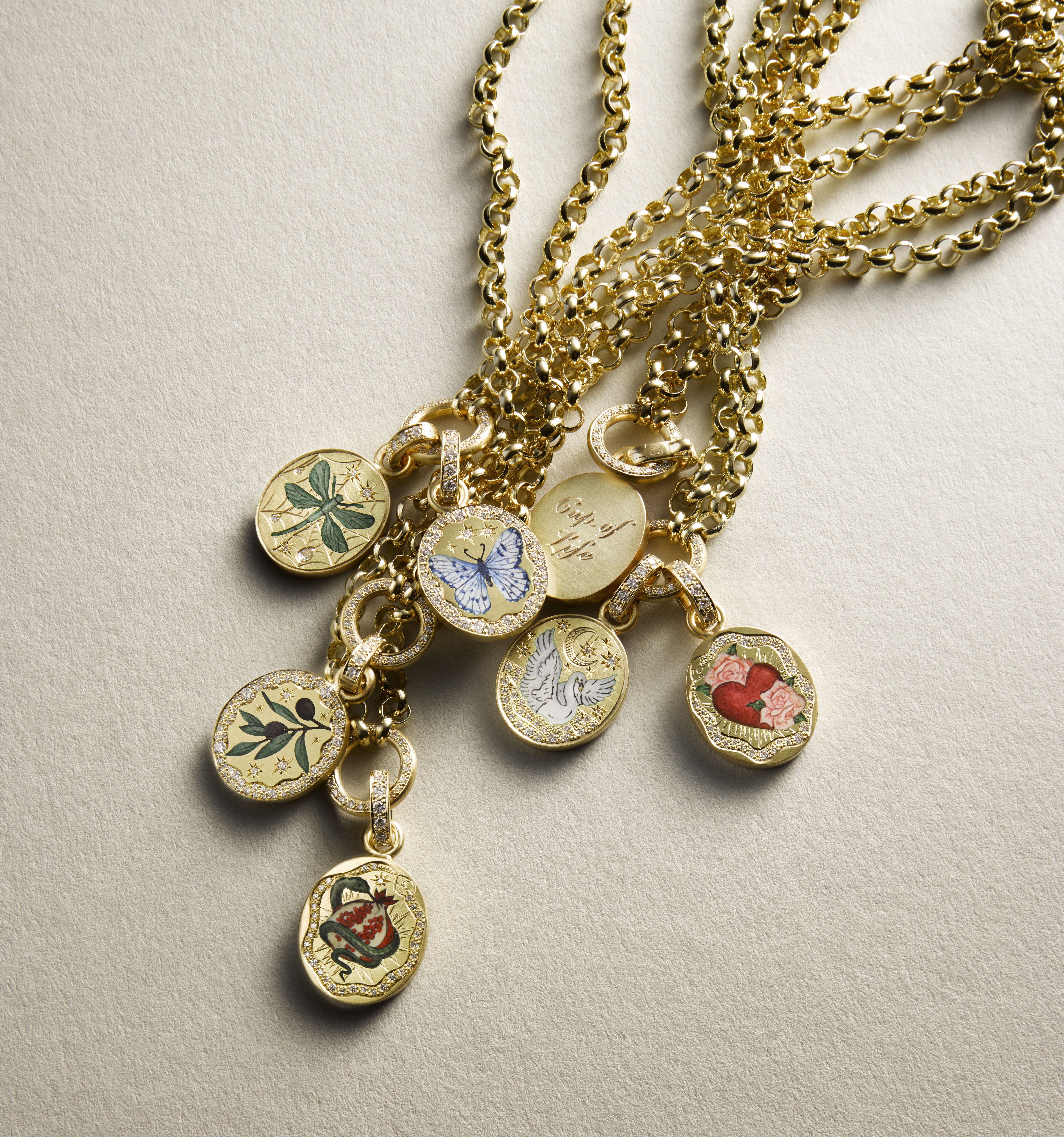 Gold necklaces with decorative pendants featuring various floral designs.