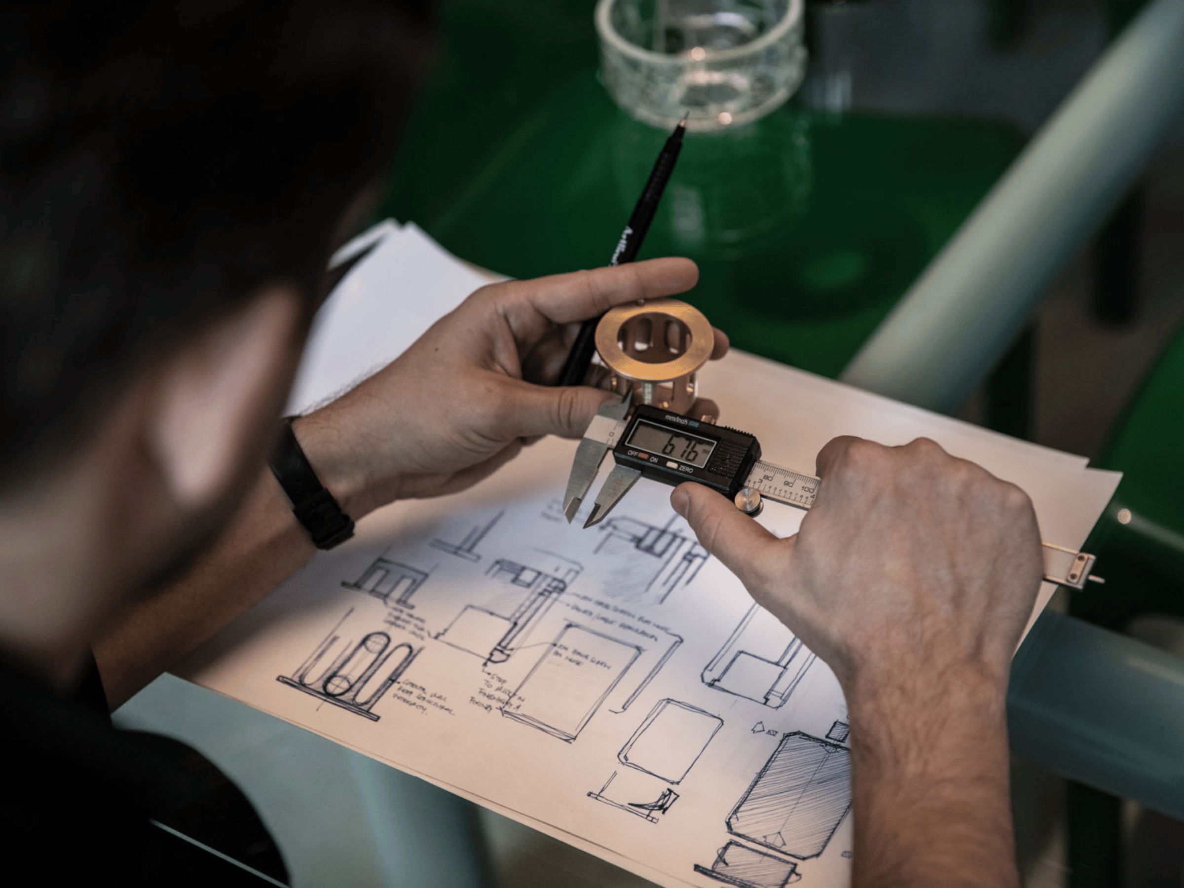 hands holding a measuring tool to measure lighting design