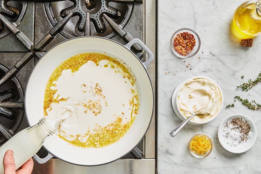 Heavy cream poured into pan.