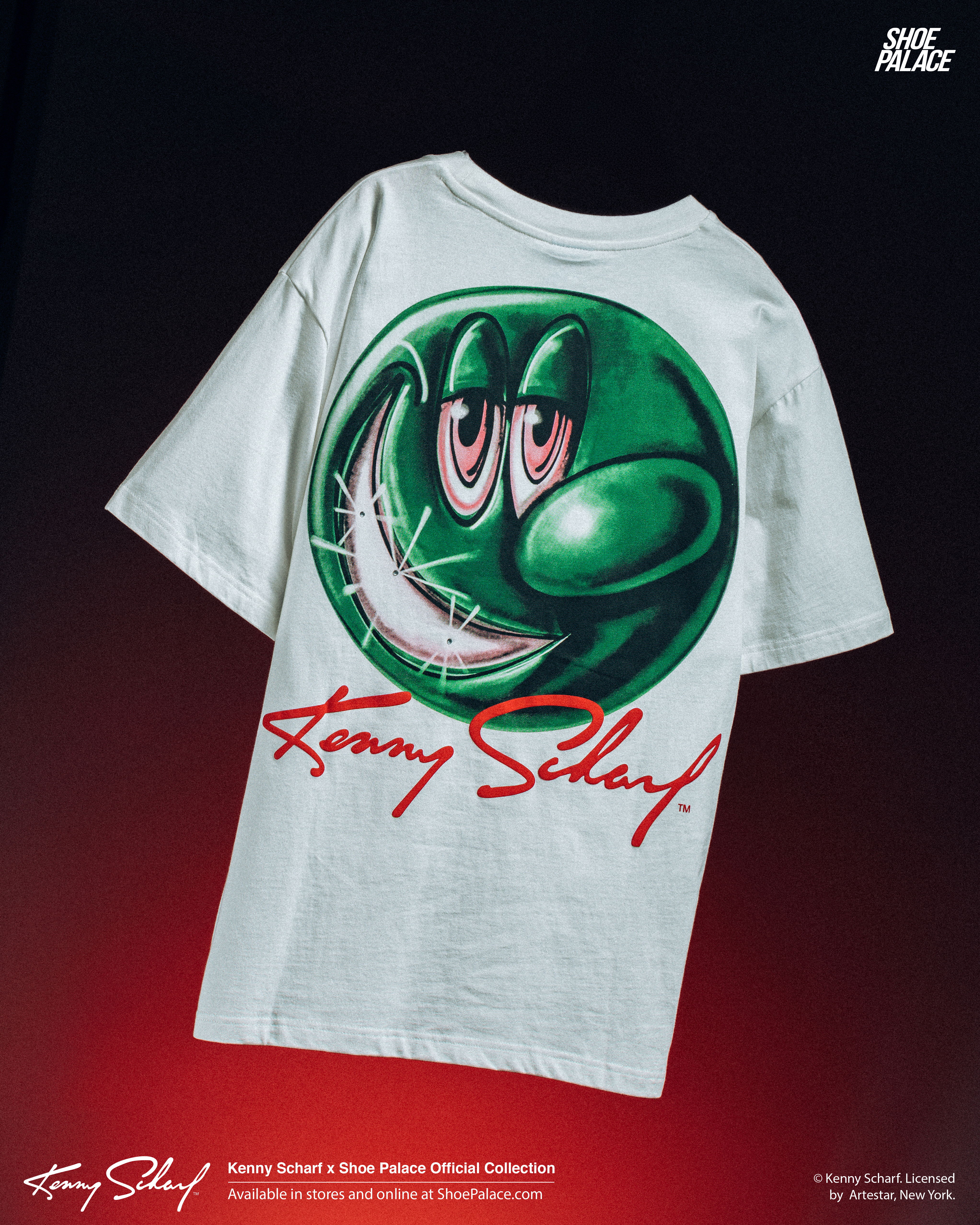 White t-shirt featuring a green cartoon character and 