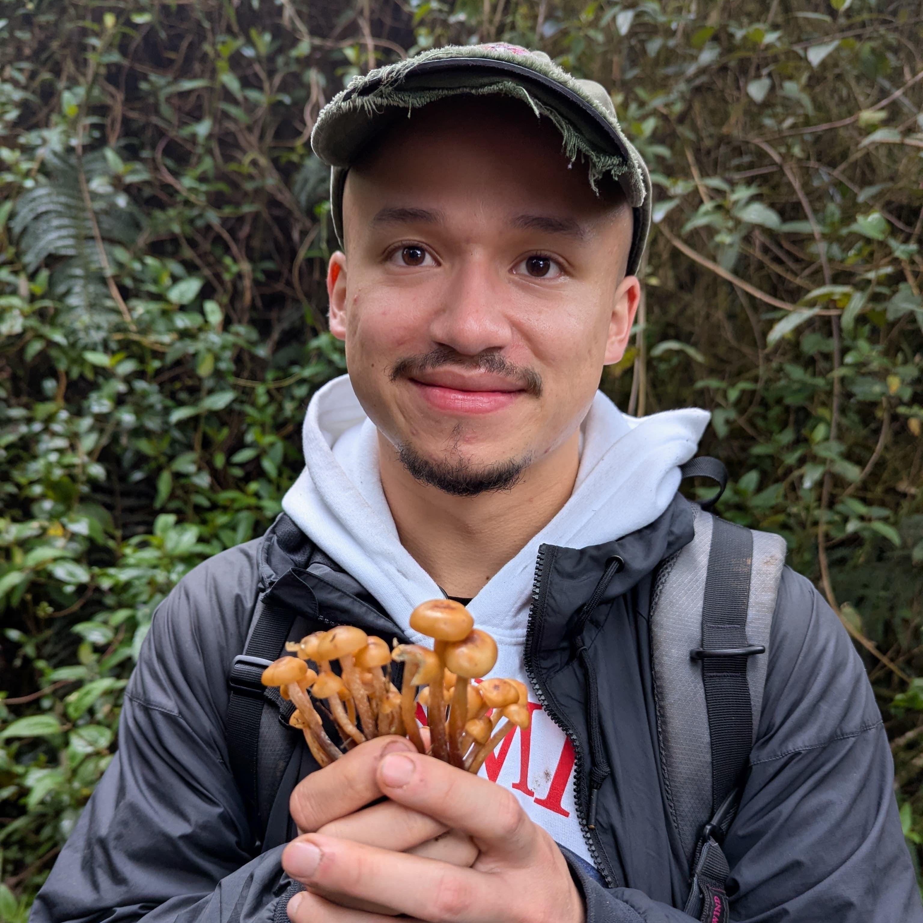 Kamilo Santana holding mushrooms