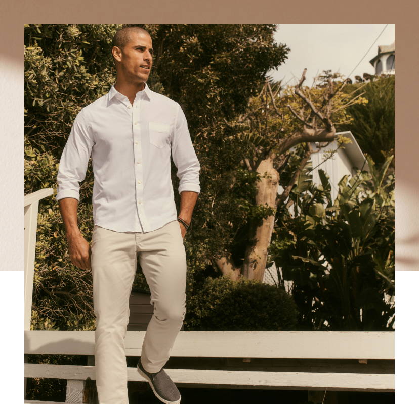 Model is wearing UNTUCKit white performance button down. 