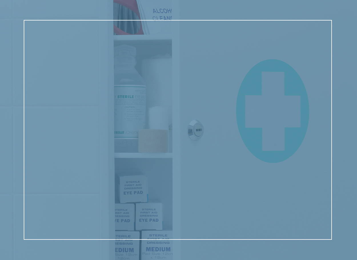  Bathroom cabinet with a white cross on a mint green circle on the half-open door, ready to hold your allergy medicine
