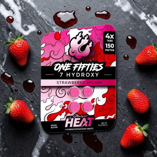 Packaging of strawberry-flavored product with strawberries and syrup on a dark surface.