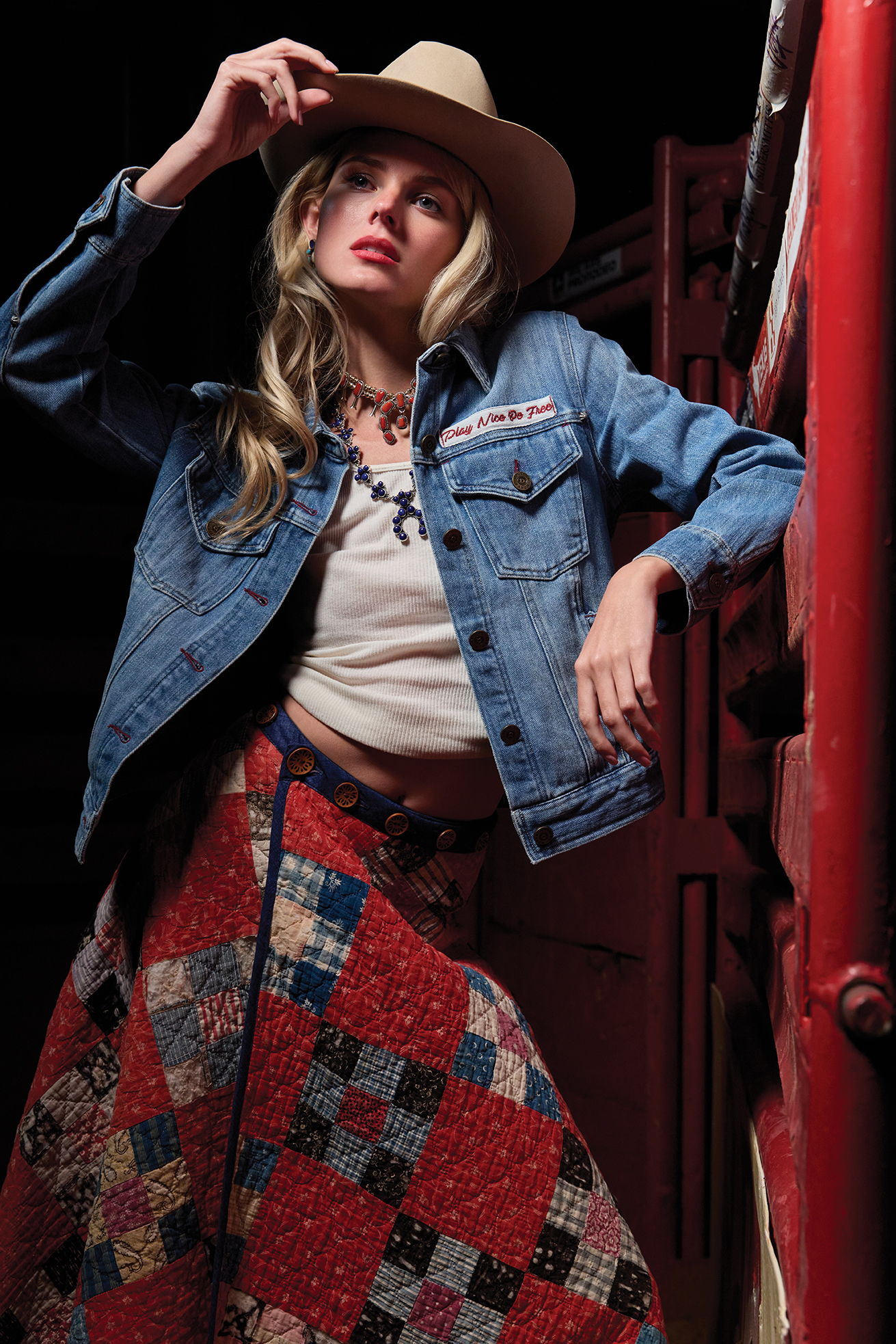 Haley wearing the Old Glory and Grit jacket with the Lady Liberty Quilt Skirt, and layered squash blossom necklaces and a vintage Double D Ranch hat.