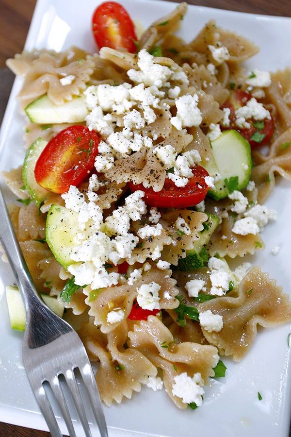 Farfalle pasta salad with feta cheese, tomatoes and cucumbers