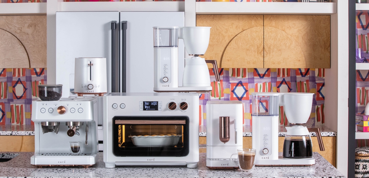 A collection of matte white kitchen appliances on a countertop.