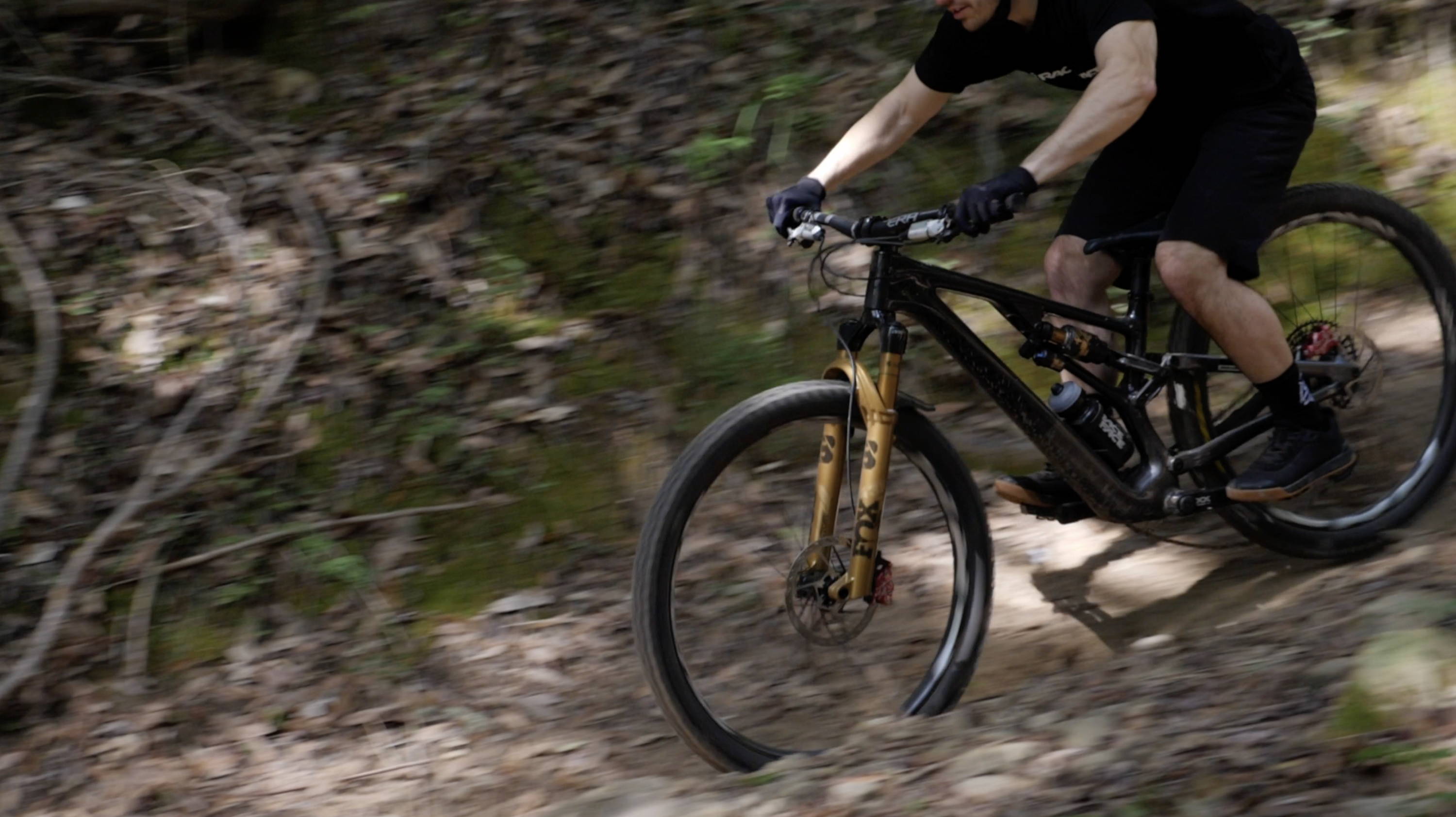 mountain biker riding specialized stumpjumper evo with fox factory 38 in podium gold on a trail in california