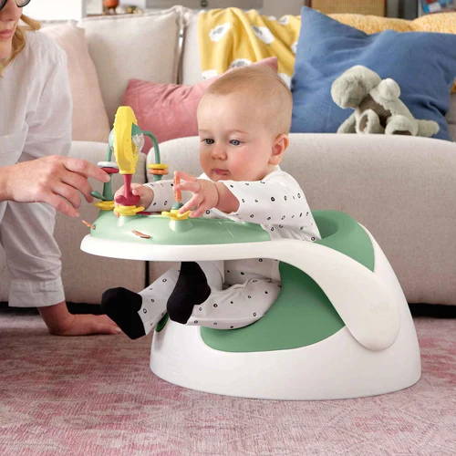 Baby in a Mamas & Papas Baby Snug Activity with Tray 