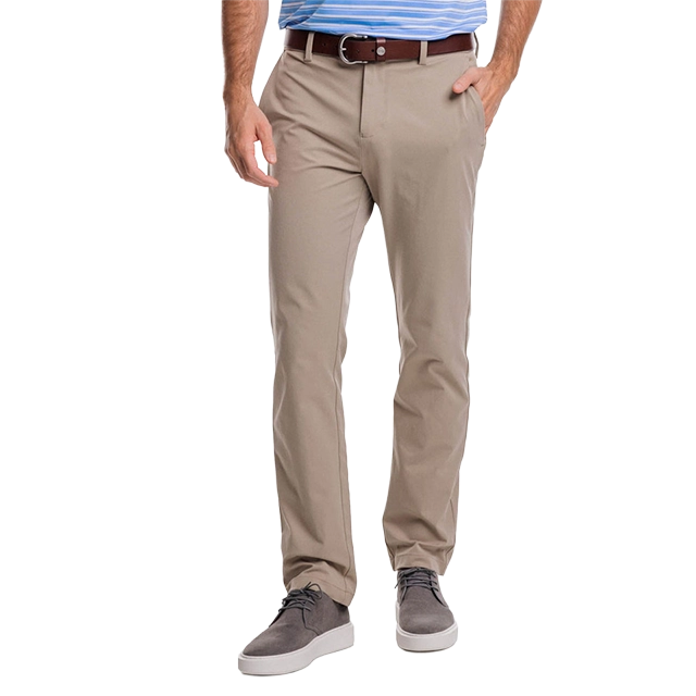 A person wearing beige pants and a blue shirt, standing casually.