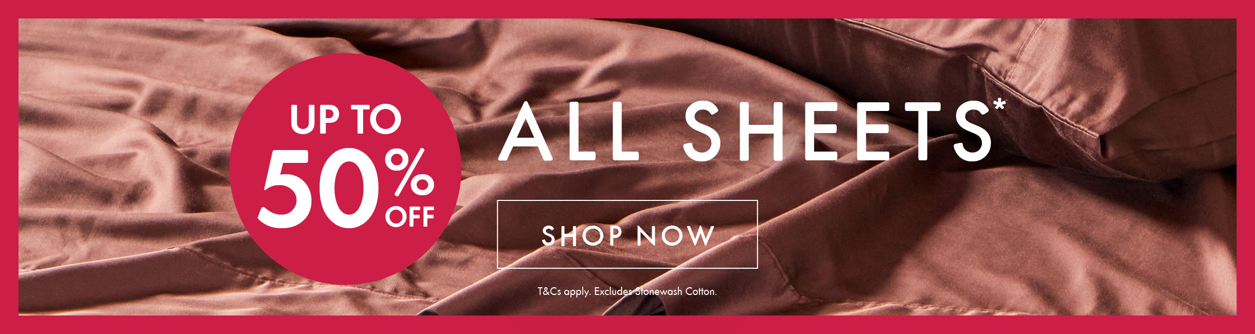 Up to 50% Off All Sheets* promotional text with Shop Now button and T&C's against a chocolate bed sheet backgroun