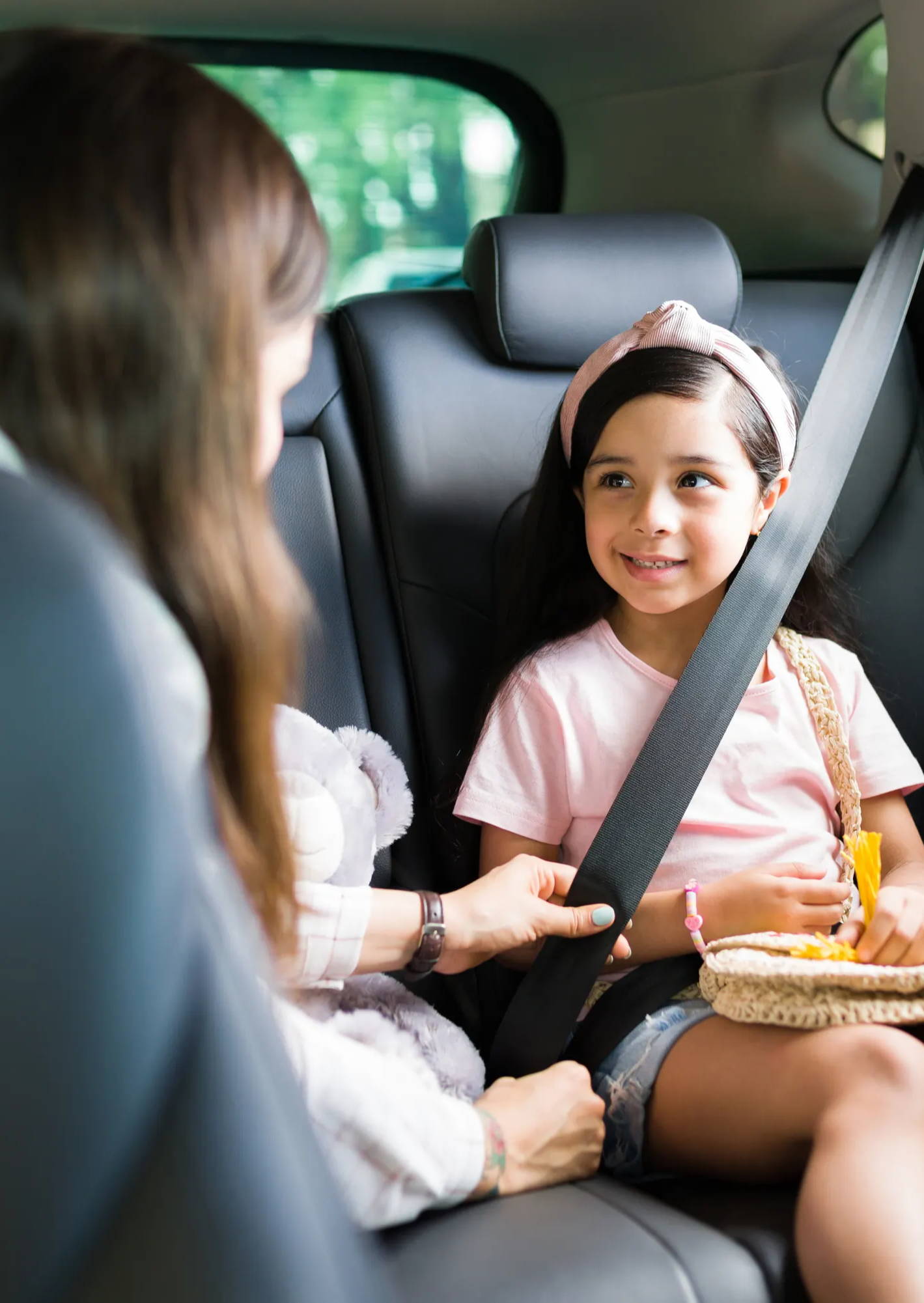 Mom and little girl smiling in car, SmartKnitKIDS, traveling with special needs child, travel with special needs child, air travel with special needs child, traveling with a child with autism, travel tips for families, travel tips for parents of young children, stress-free traveling tips, traveling with an autistic kid, airplane travel with an autistic child, traveling with kids, traveling with children, children with anxiety, travel expectations, sensory processing disorder