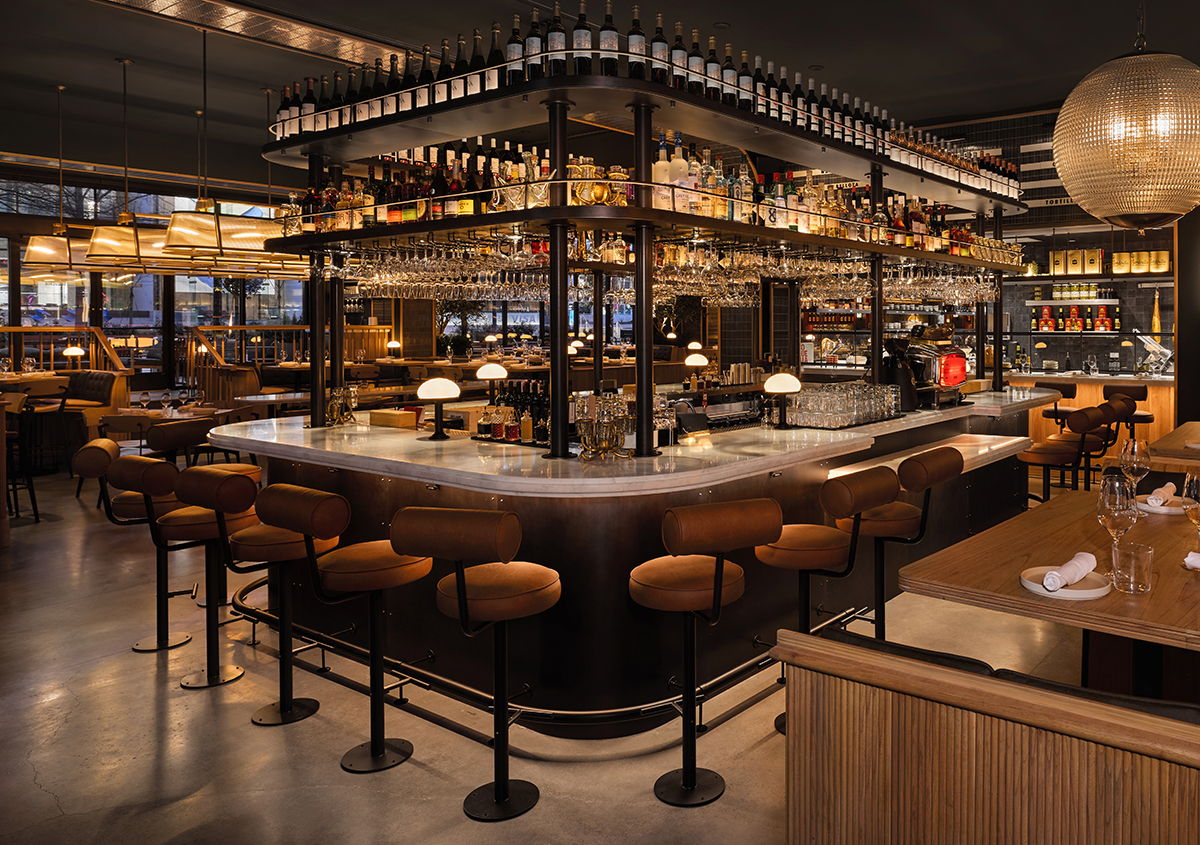 Modern restaurant interior featuring a stylish bar with Kegworks bar foot rail and glass racks