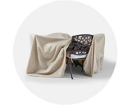 A chair covered with a beige fabric drape.