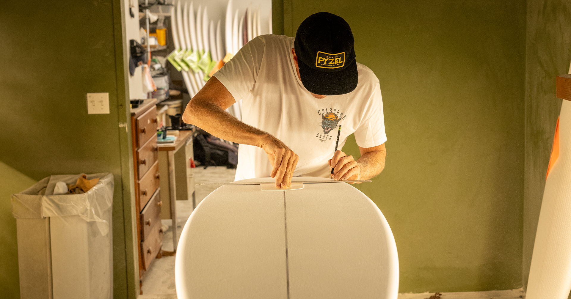 Person assembling a piece of furniture in a room with green walls.