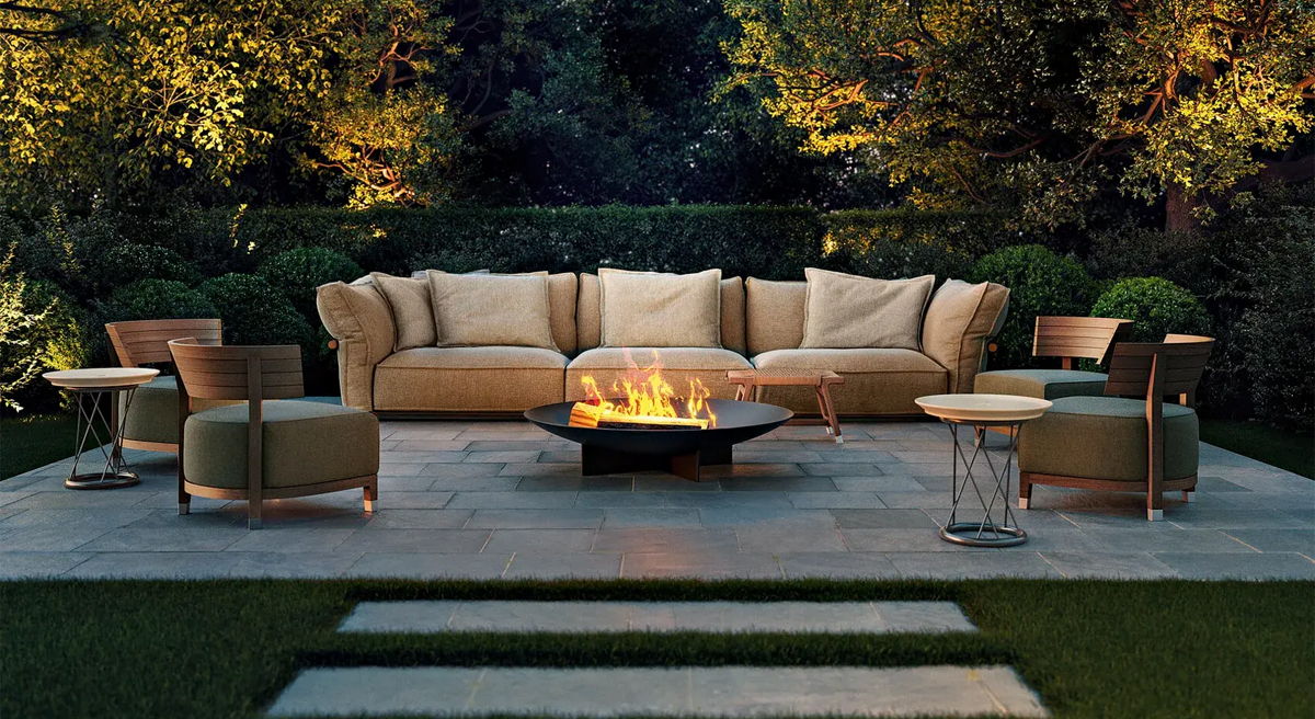 Cozy outdoor seating area with a fire pit surrounded by greenery.