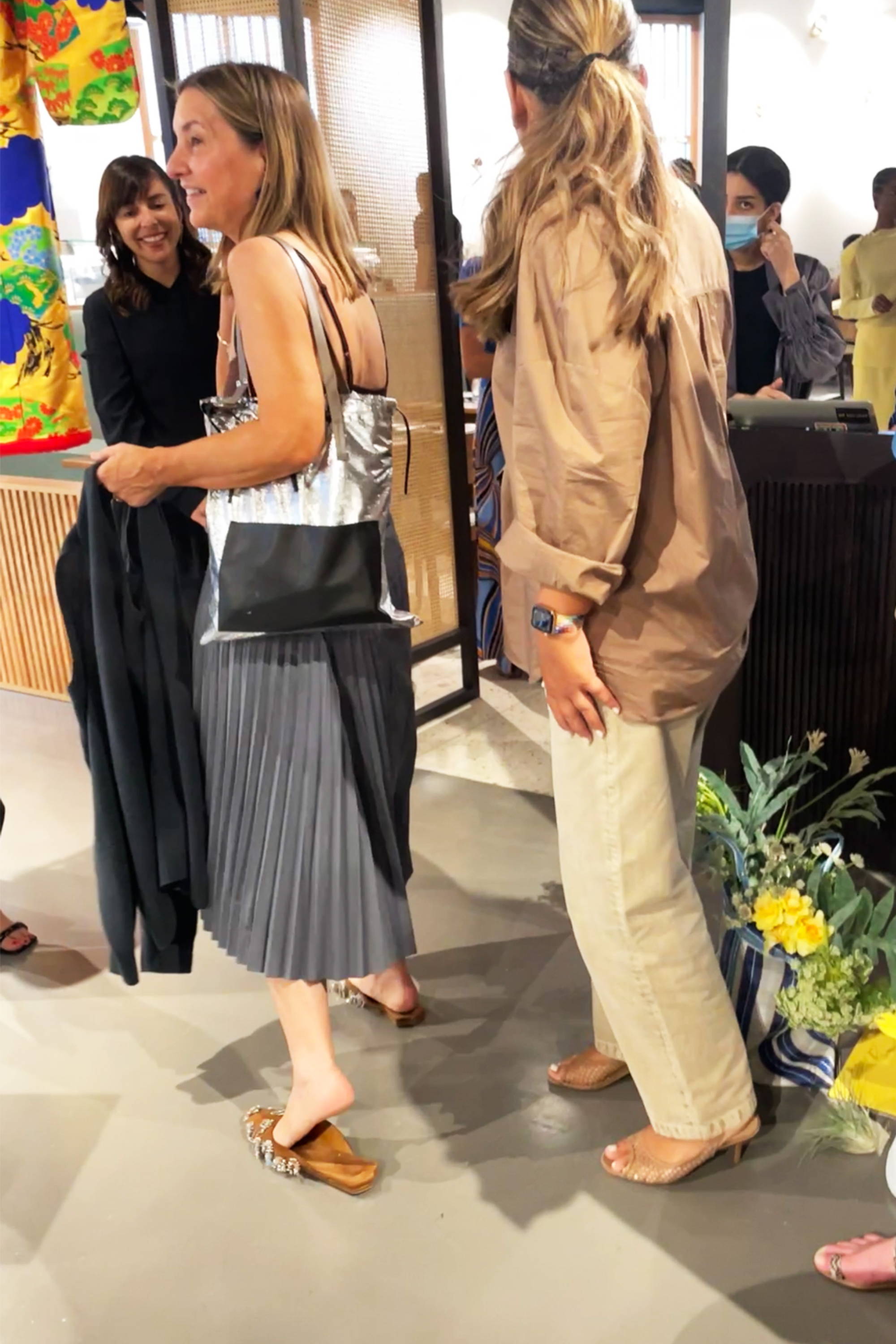 Group of people chatting in a modern indoor setting.