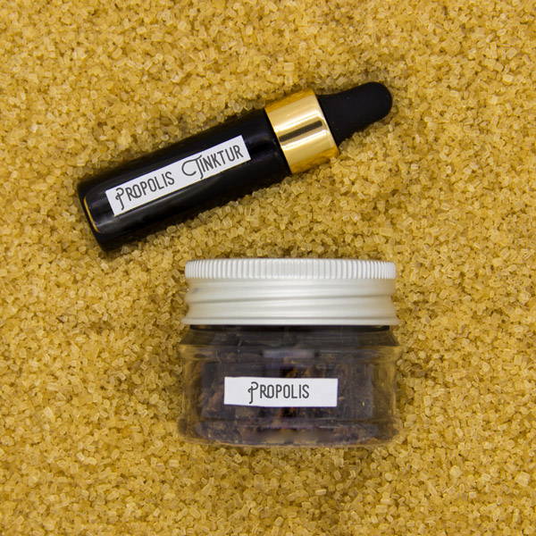 Propolis tincture and propolis on a sugar background