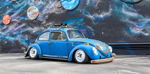 Blue Super Beetle parked at mural wall side profile roof-mounted horn setup Zach's 1971 Volkswagen Shocker XL gallery photo 2