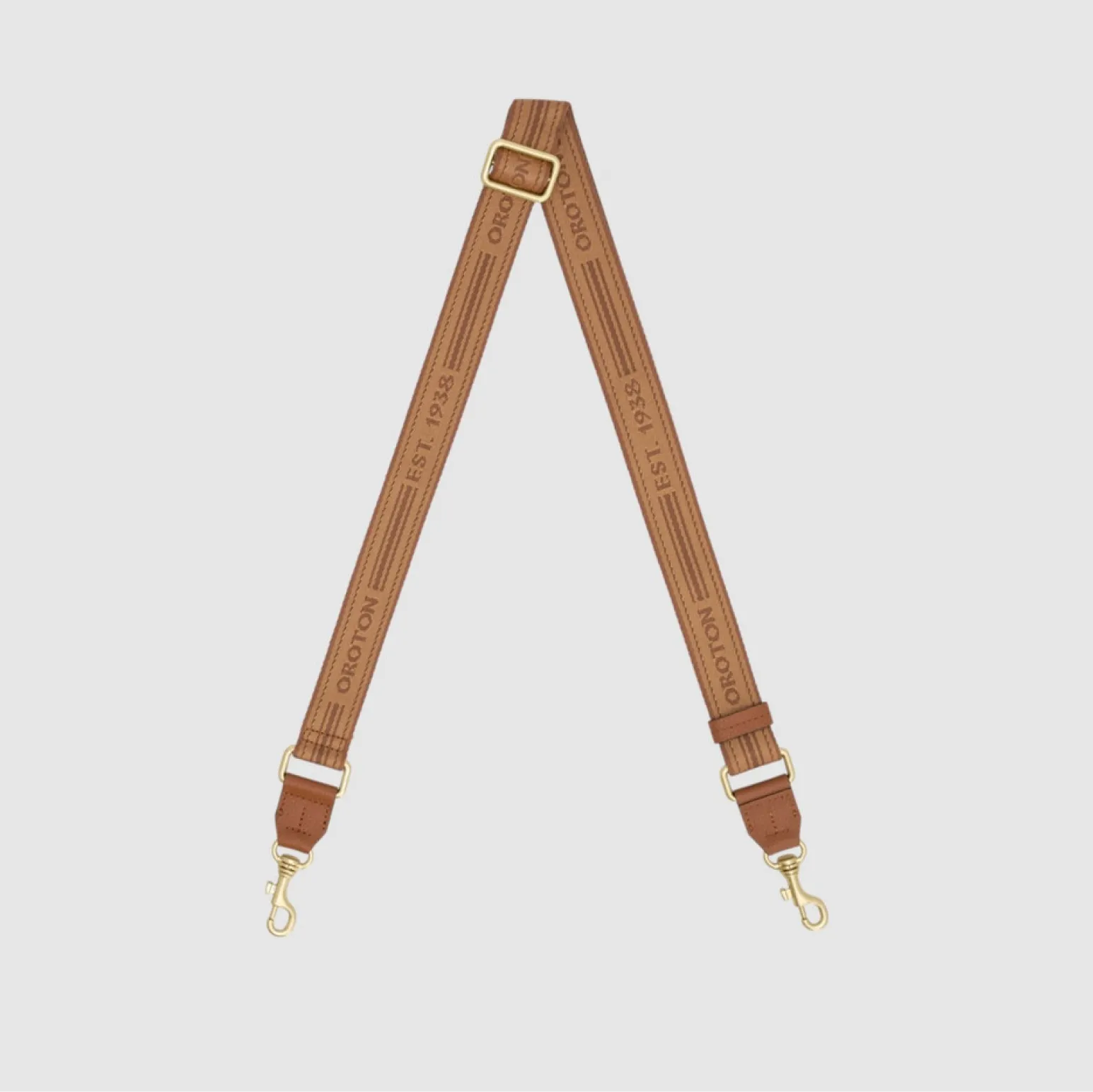 Brown leather strap with gold clasps, featuring text along its length.
