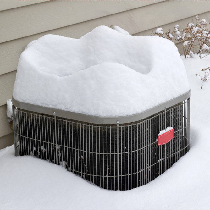 heat pump covered in snow during winter