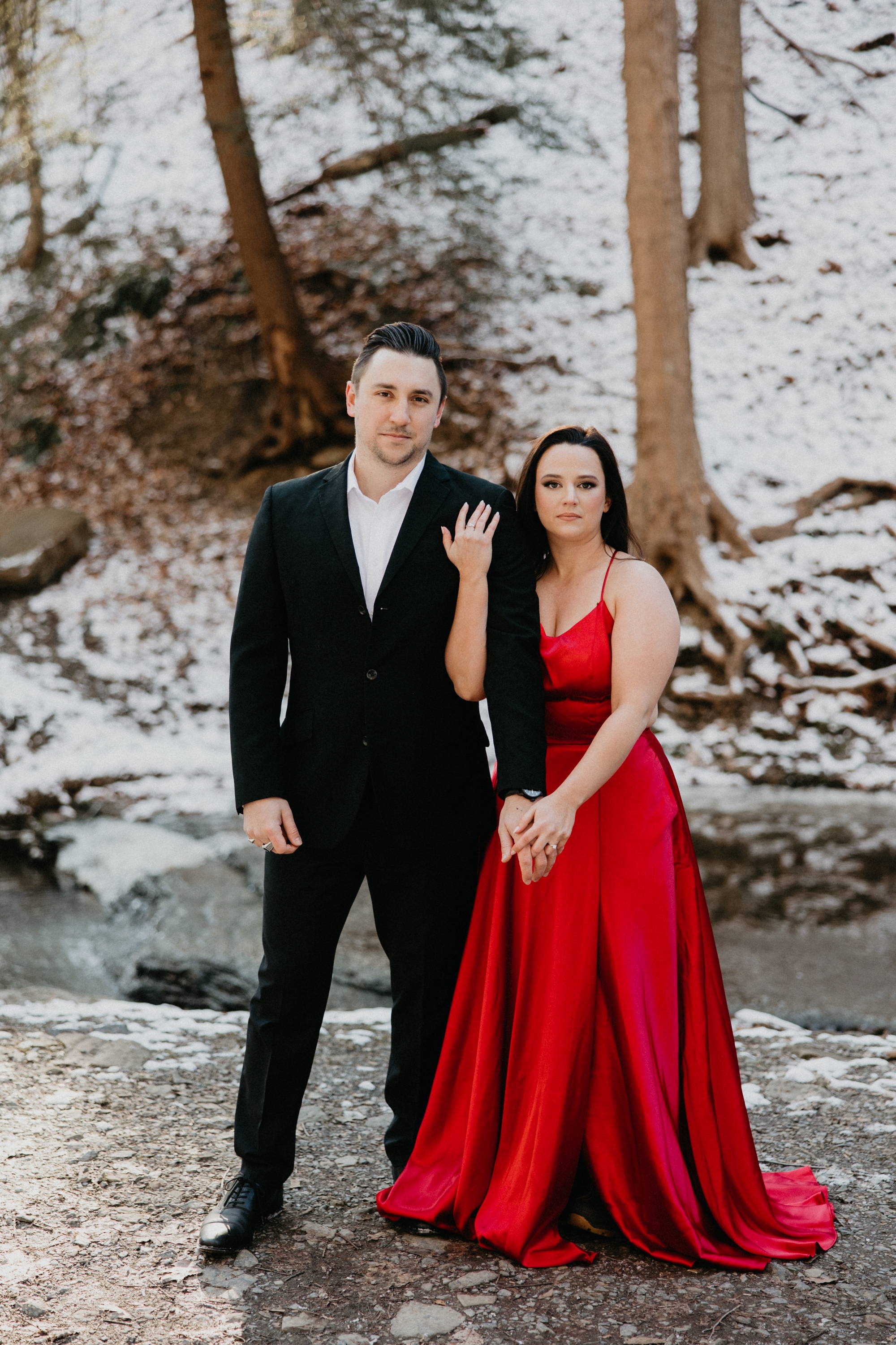 Leigh in red dress holding hands with Kyle