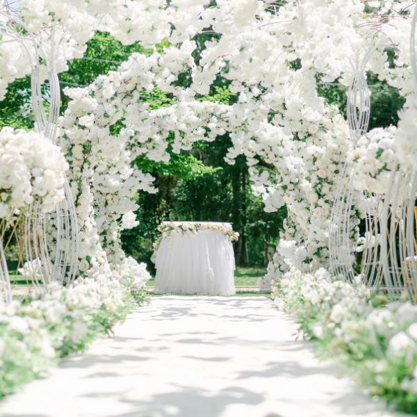 White outdoor wedding with excess of flowers