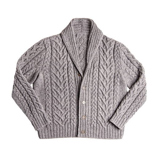 A hand knit shawl collar allover cabled cardigan photographed flat on a white background 