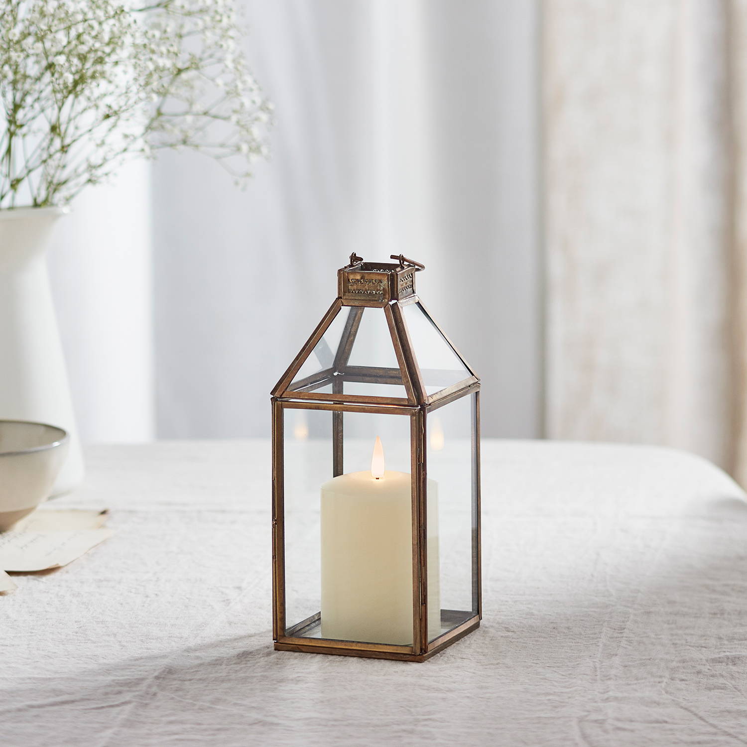 Artisan lantern with TruGlow candle illuminated on table
