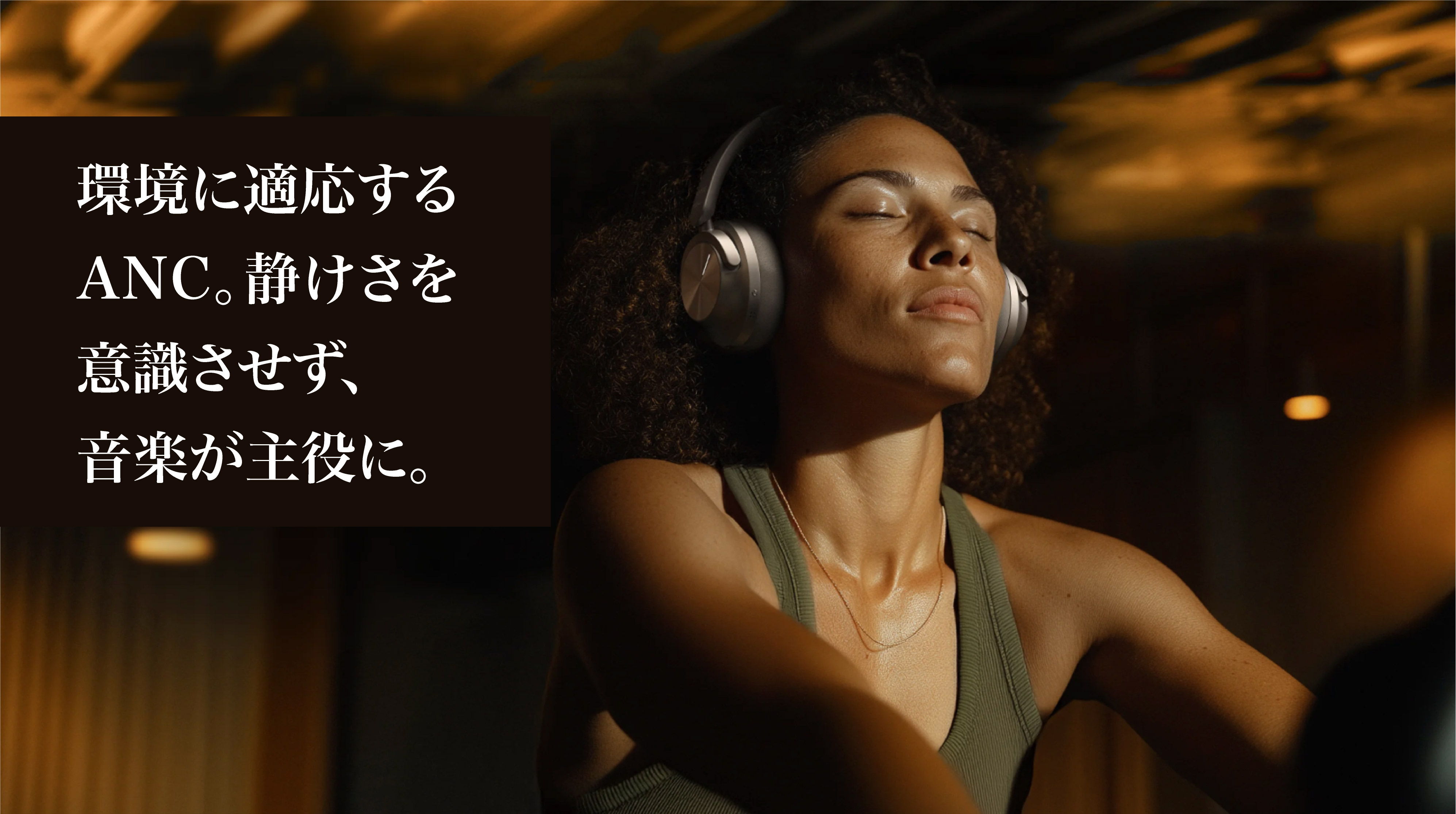 A woman wearing headphones, enjoying music in a serene environment.