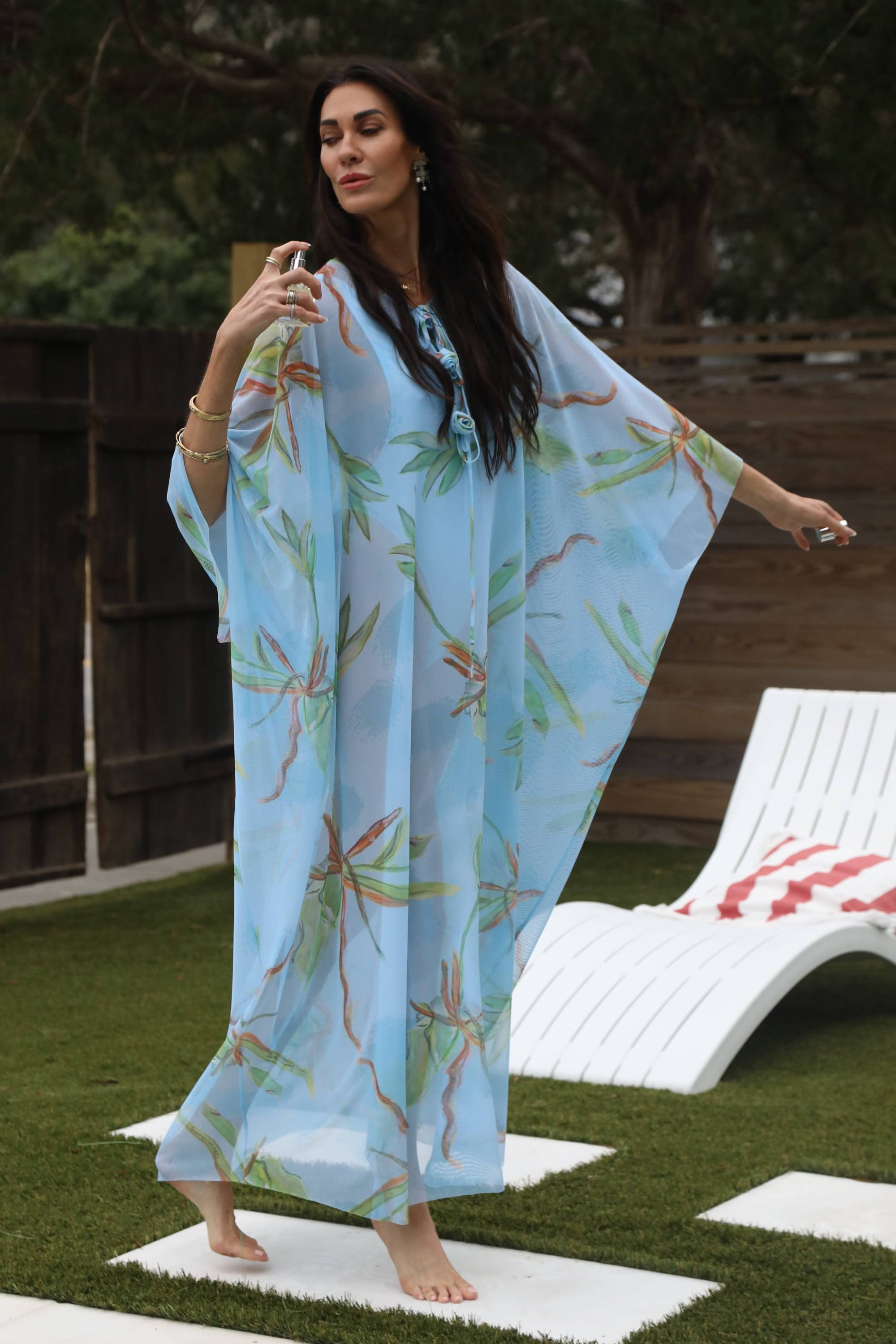 Muffy founder of the Buzz Skin wearing mesh bathing suit cover up with her fragrance by the pool by Ala von Auersperg
