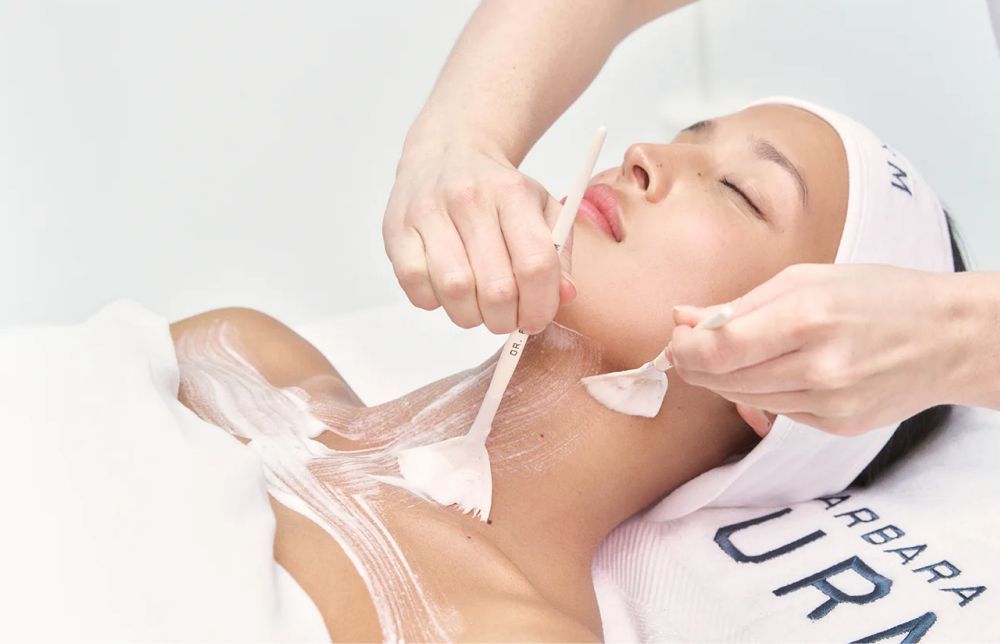 A woman receiving a facial treatment at a spa or salon.