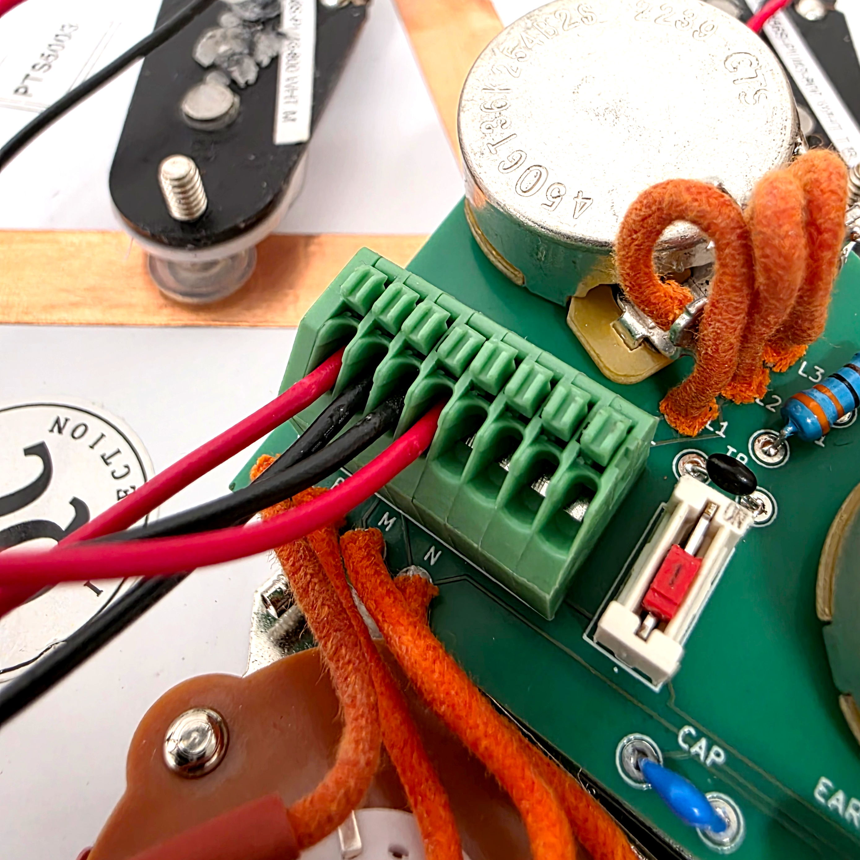 Close-up of a circuit board with wiring connections and components.