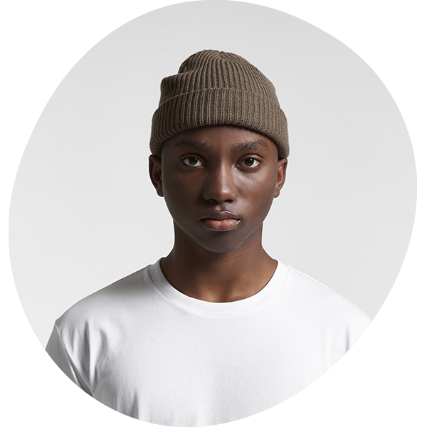 Model wearing a brown cable-knit beanie
